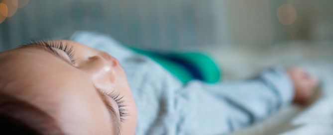 Sleeping toddler in cot bed